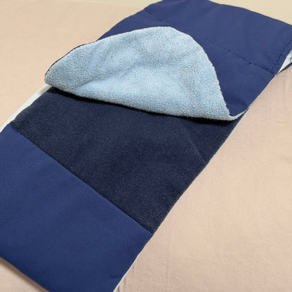 SomniGrave Weighted Sleep Mask folded to show quiet-touch adjustable closure with navy ice silk and light blue soft plush sides